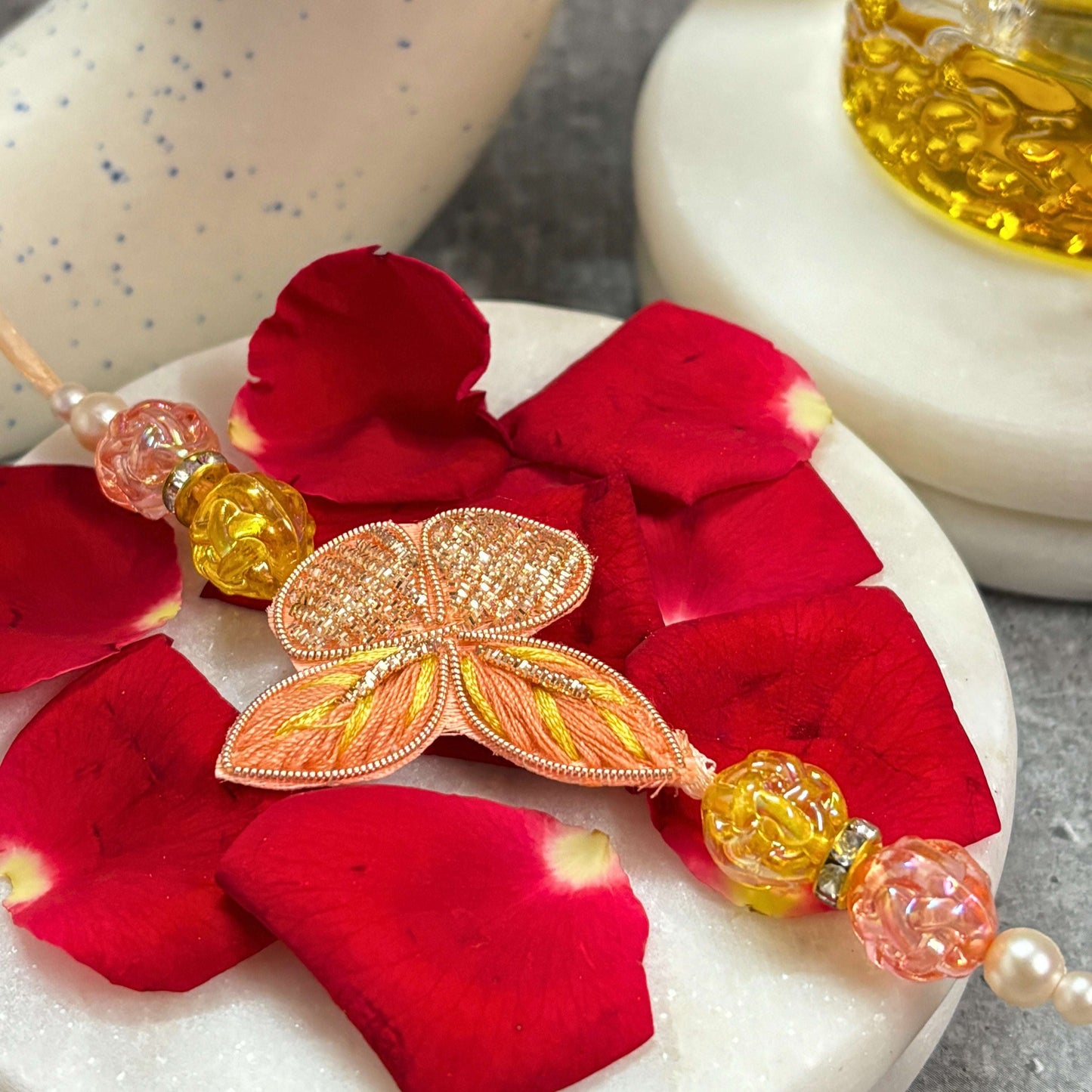 Designer Butterfly Rakhi with Latkan Rakhi for Bhaiya Bhabhi adorned with colorful beads and rose petals