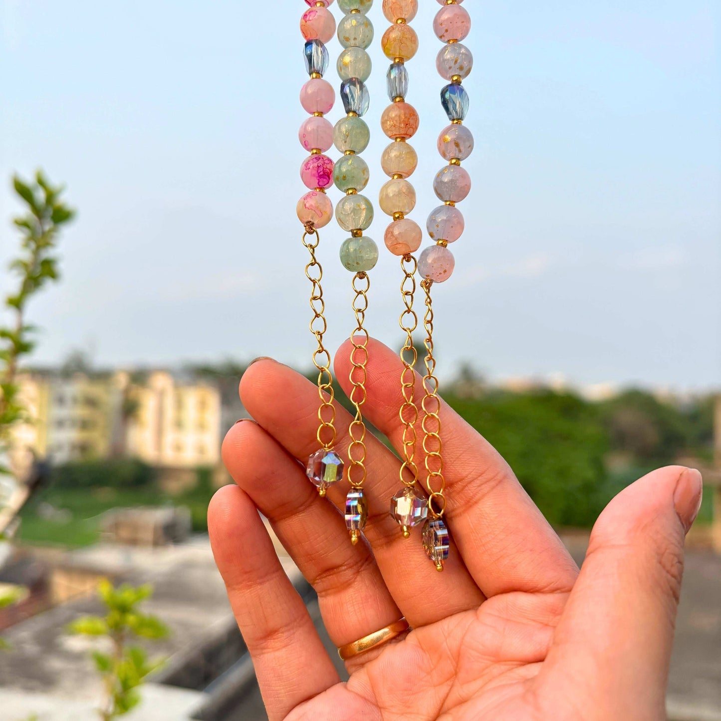 TyohaarVibe Marble Effect Beaded Bracelet Combo with colorful beads and gold accents in a hand display