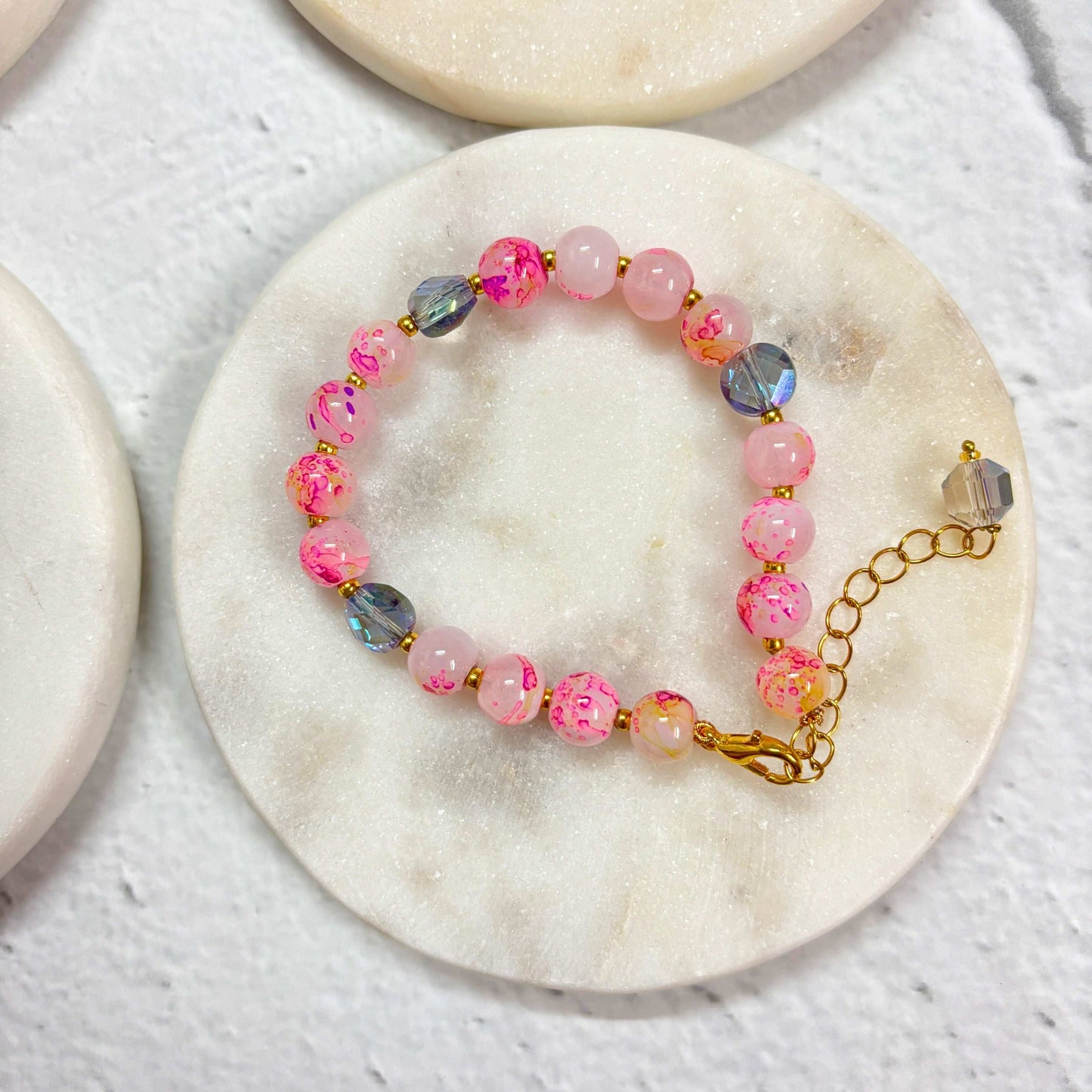 TyohaarVibe Marble Effect Beaded Bracelet Combo with pink and shimmering beads on a marble backdrop
