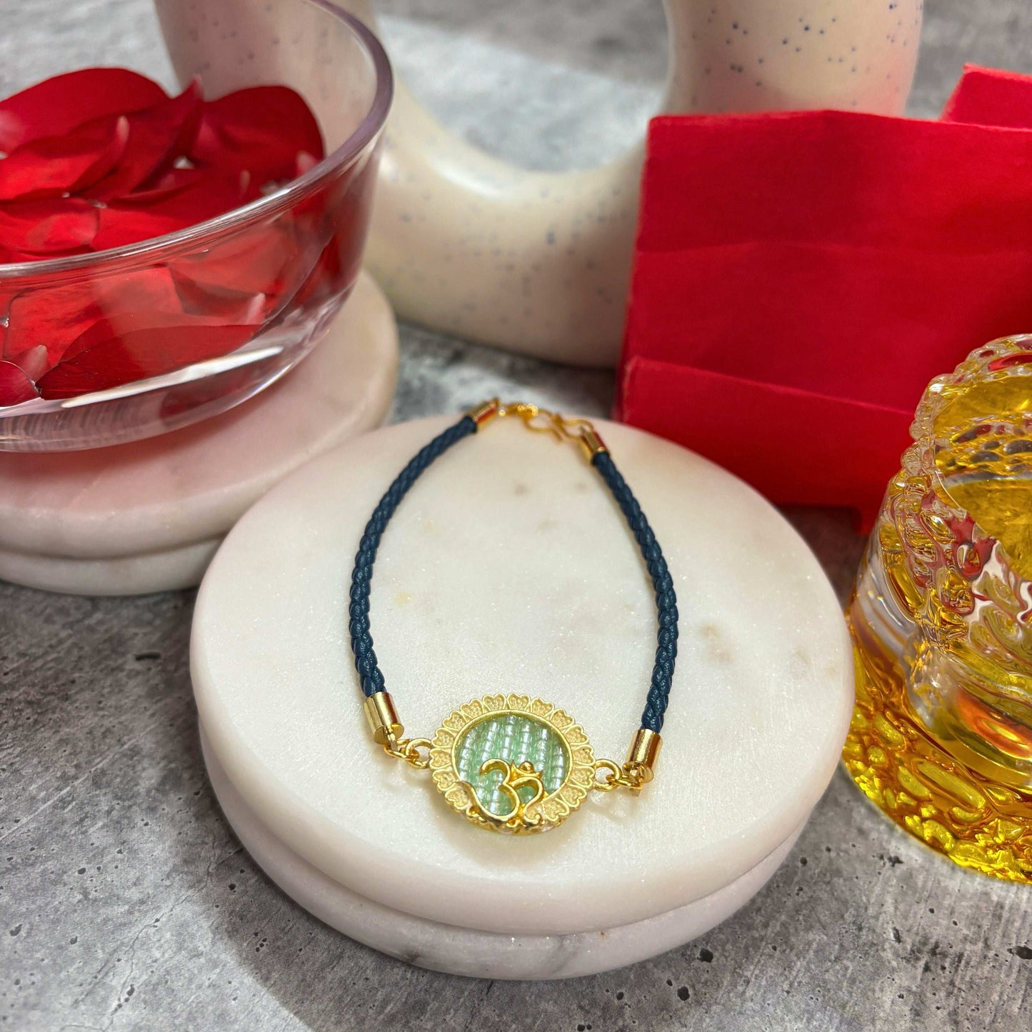 Om Symbol Rakhi for Raksha Bandhan by TyohaarVibe with blue thread and decorative charm