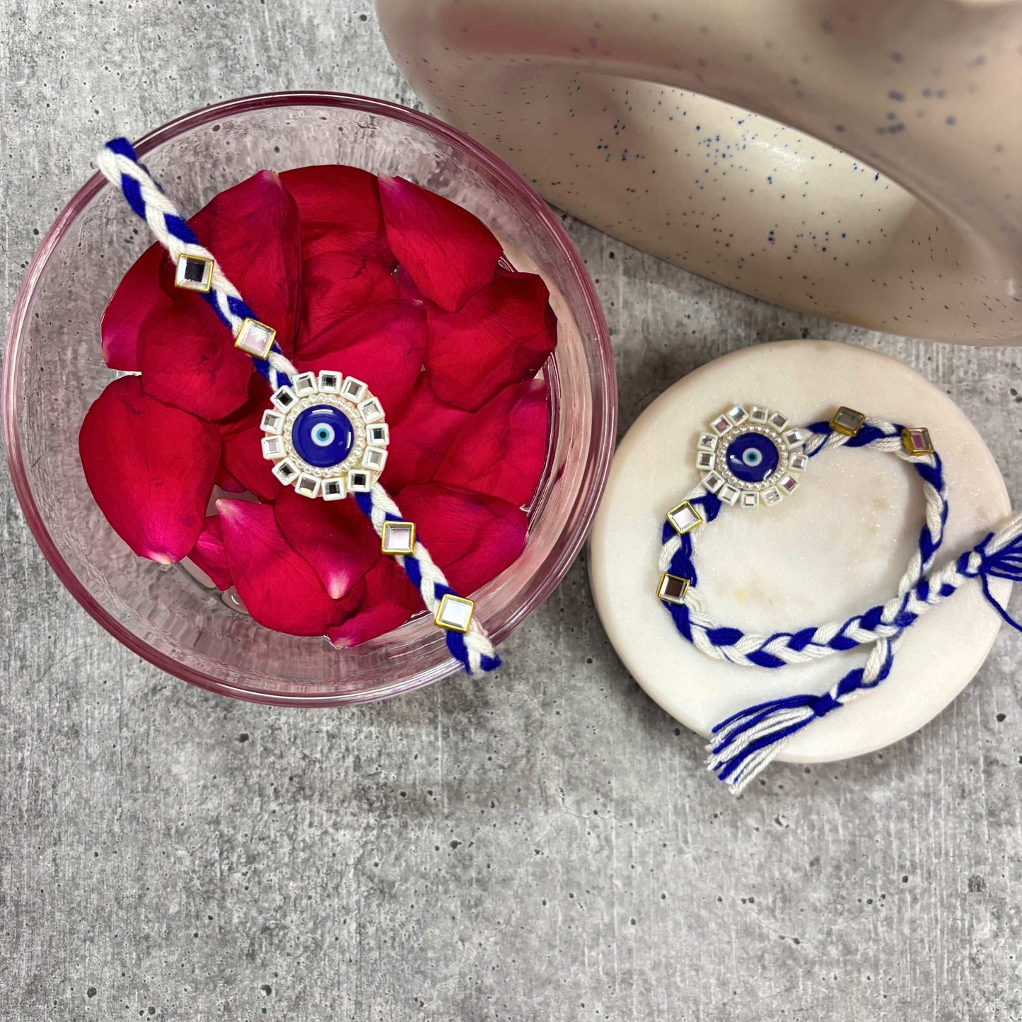 Evil Eye Designer Rakhi Raksha Bandhan 2025 with intricate design and vibrant colors on decorative plate