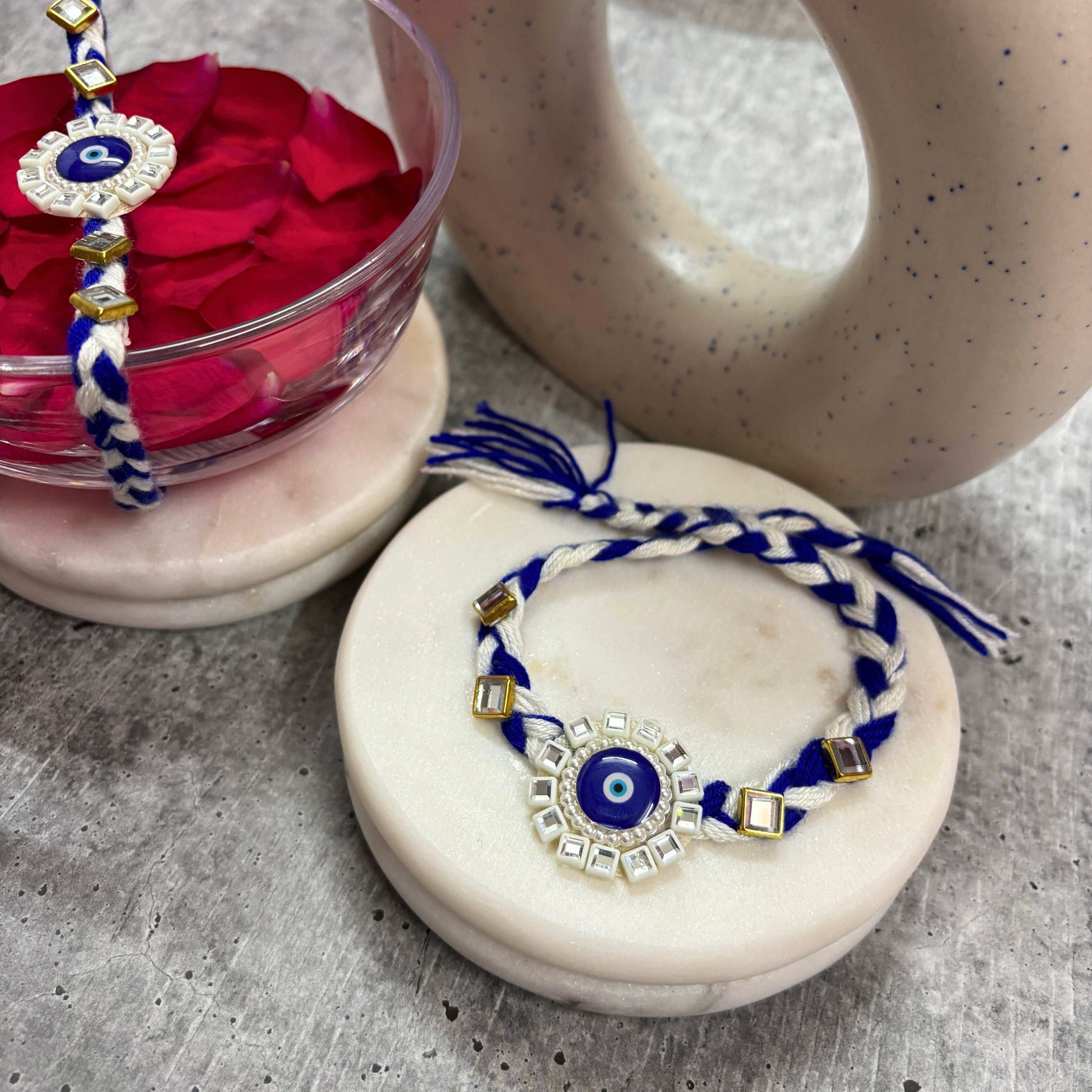 Evil Eye Designer Rakhi Raksha Bandhan 2025 featuring blue and white beads with decorative gold accents